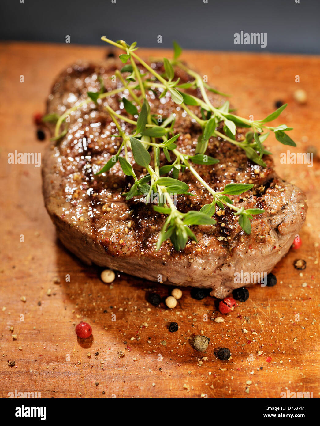 Fried beef tenderloin steak with thyme and peppers. Stock Photo