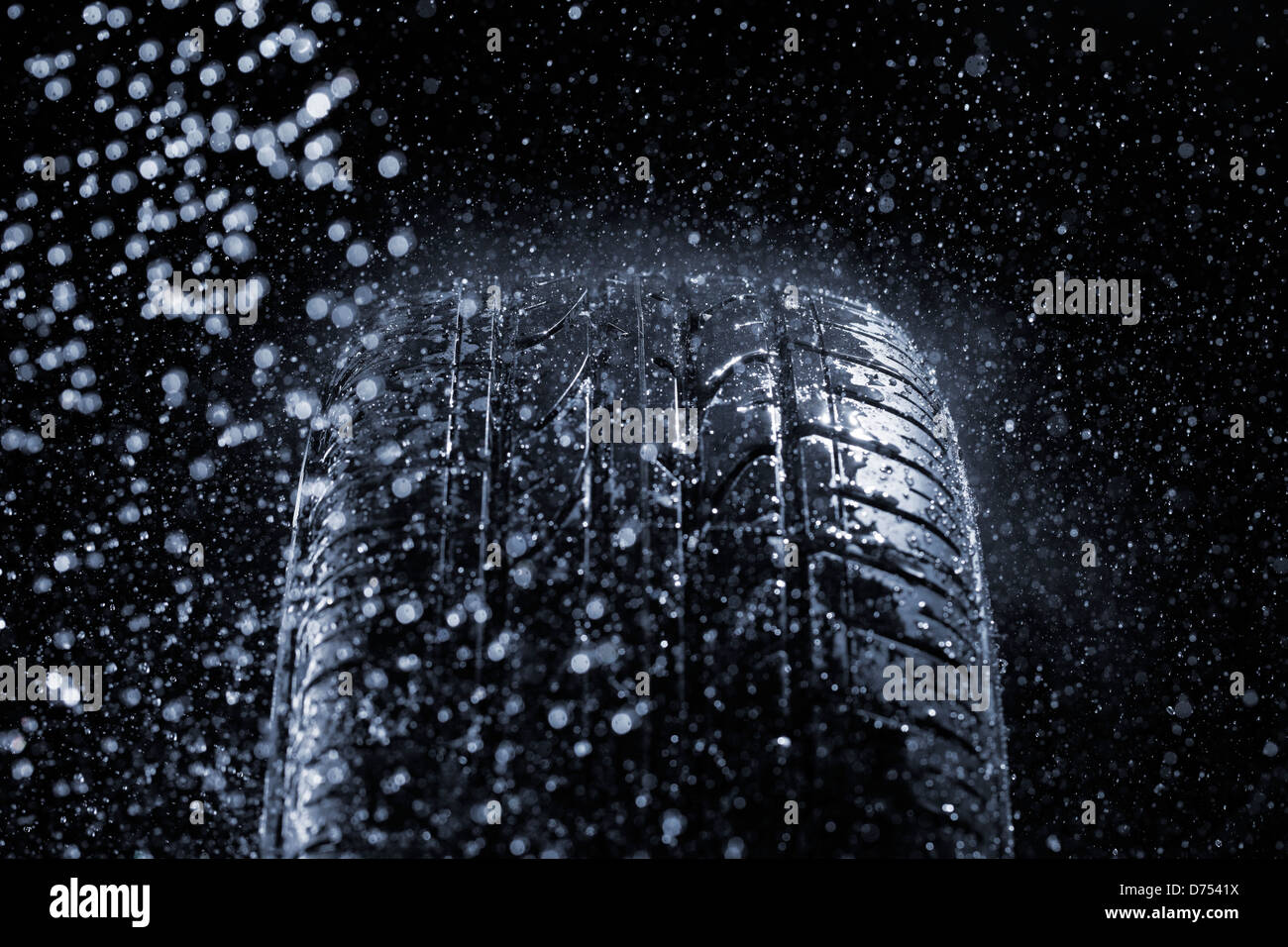 Car tire in rainy conditions. Very short depth-of-field. Stock Photo