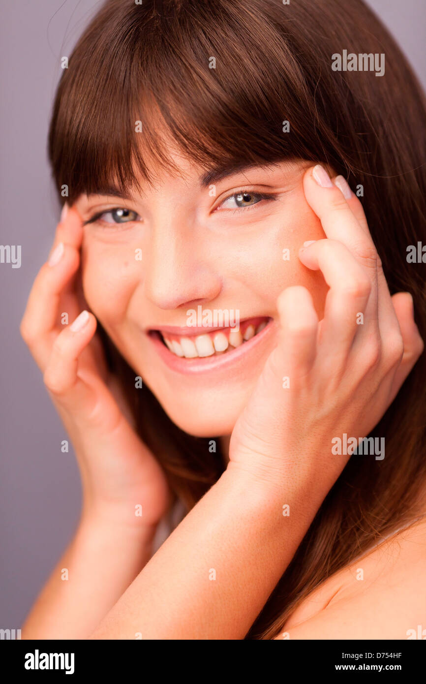 woman pulling the corners of her eyes Stock Photo Alamy