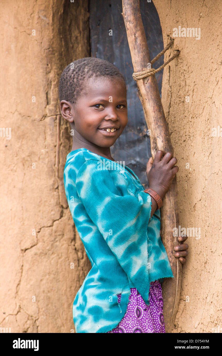 Masai Girl at entrance to mud hut Stock Photo