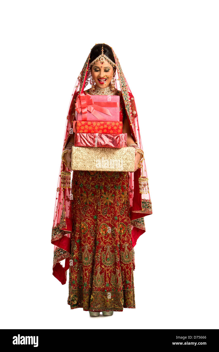 Smiling Indian Bride In Traditional Wedding Dress Holding Gifts
