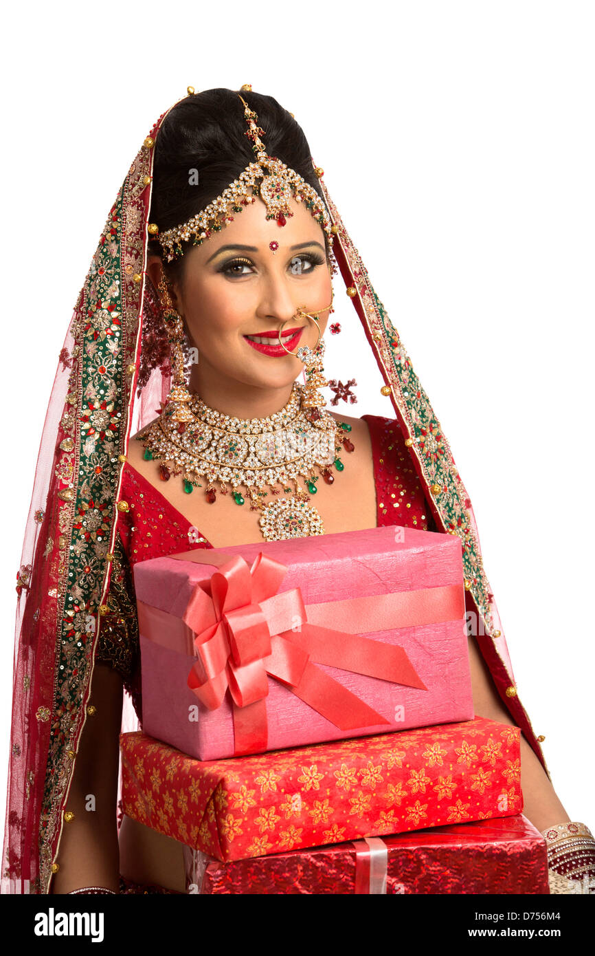 Smiling Indian Bride In Traditional Wedding Dress Holding Gifts