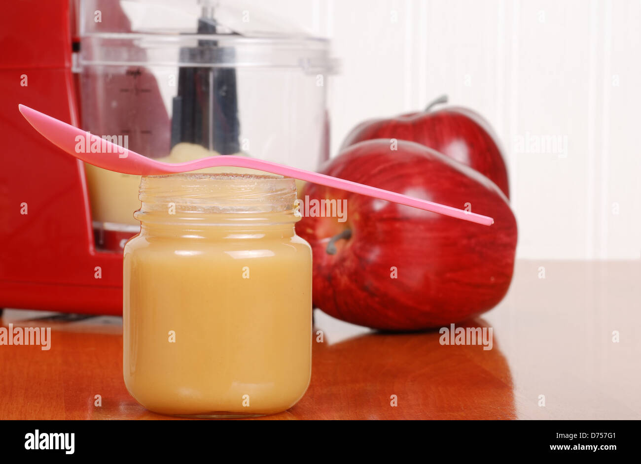 homemade apple sauce baby food with spoon Stock Photo