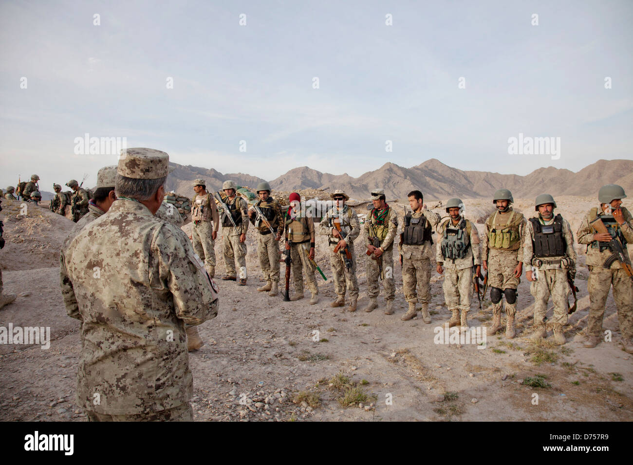 US Marines and Afghan National Civil Order Policemen brief before a patrol during Operation California to clear enemy insurgents from the village of Loy Mandah April 28, 2013 in Kajaki District, Helmand province, Afghanistan. Stock Photo