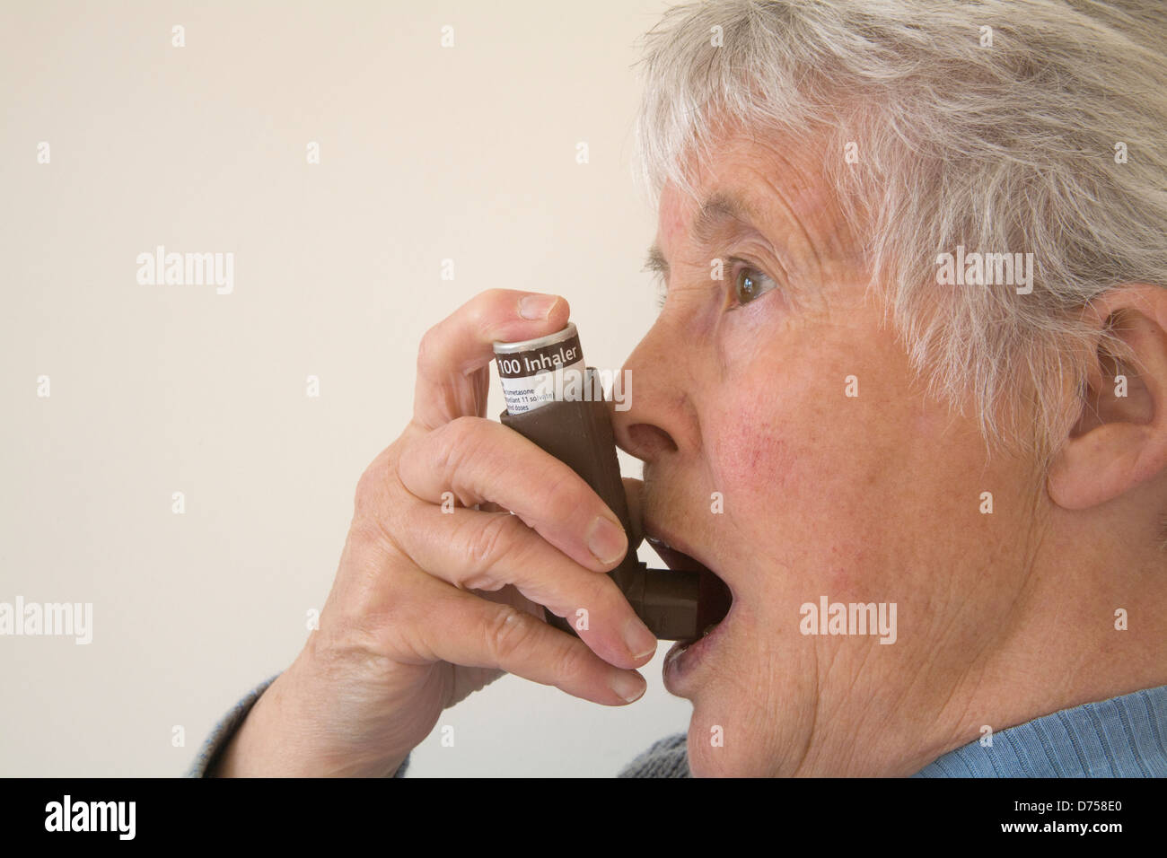 Elderly woman asthma using inhaler hires stock photography and images