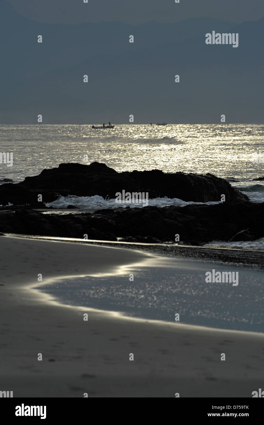 Fishermen boat in the sea at sunset Stock Photo - Alamy