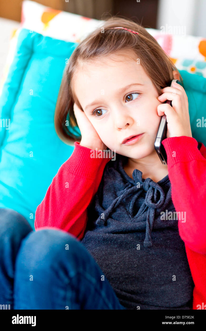 4 year old girl using a cell phone. Stock Photo