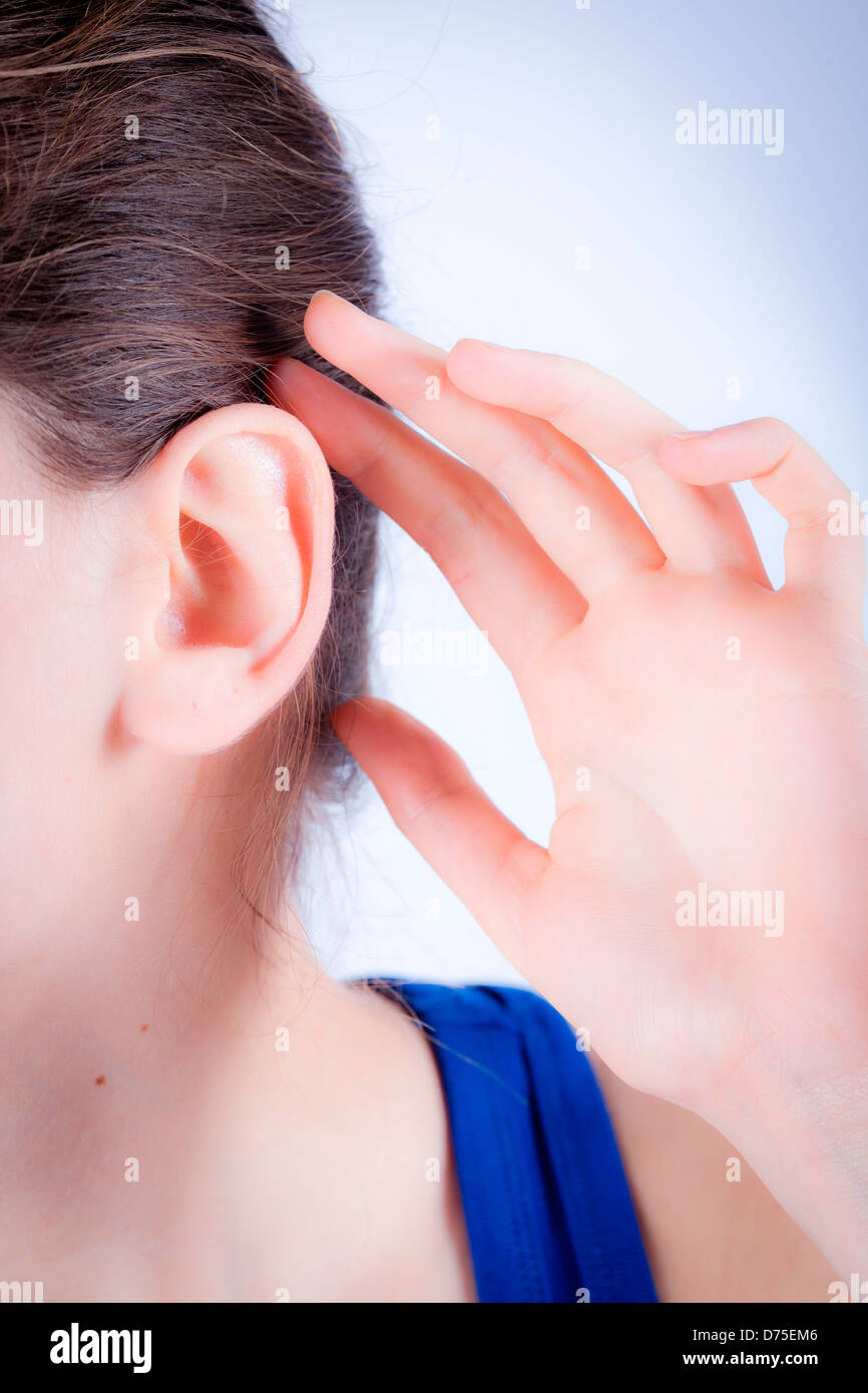 woman holds her hand to her painful ear. Stock Photo