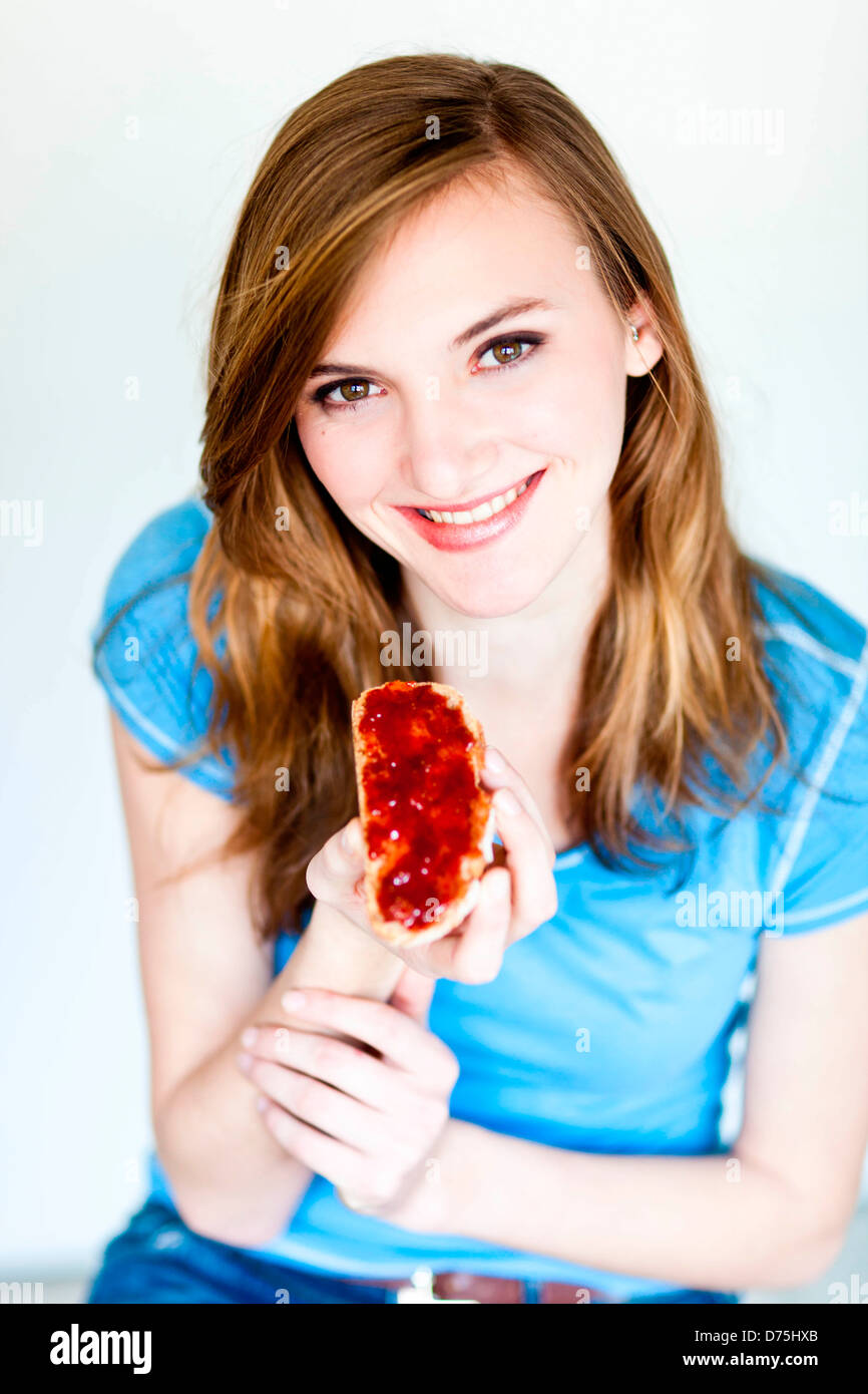 woman eating a jam sandwich Stock Photo Alamy