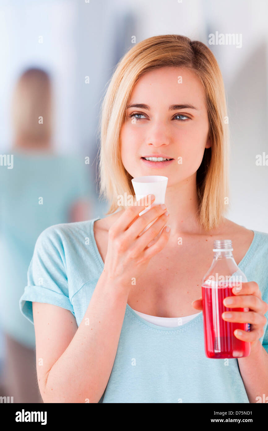 Woman using mouthwash Stock Photo Alamy