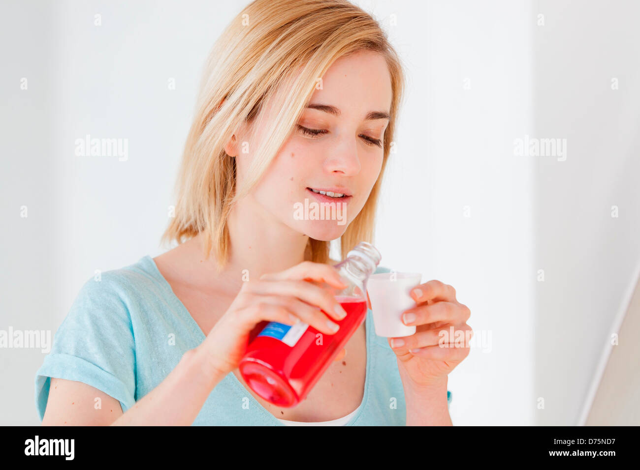 Woman using mouthwash Stock Photo Alamy