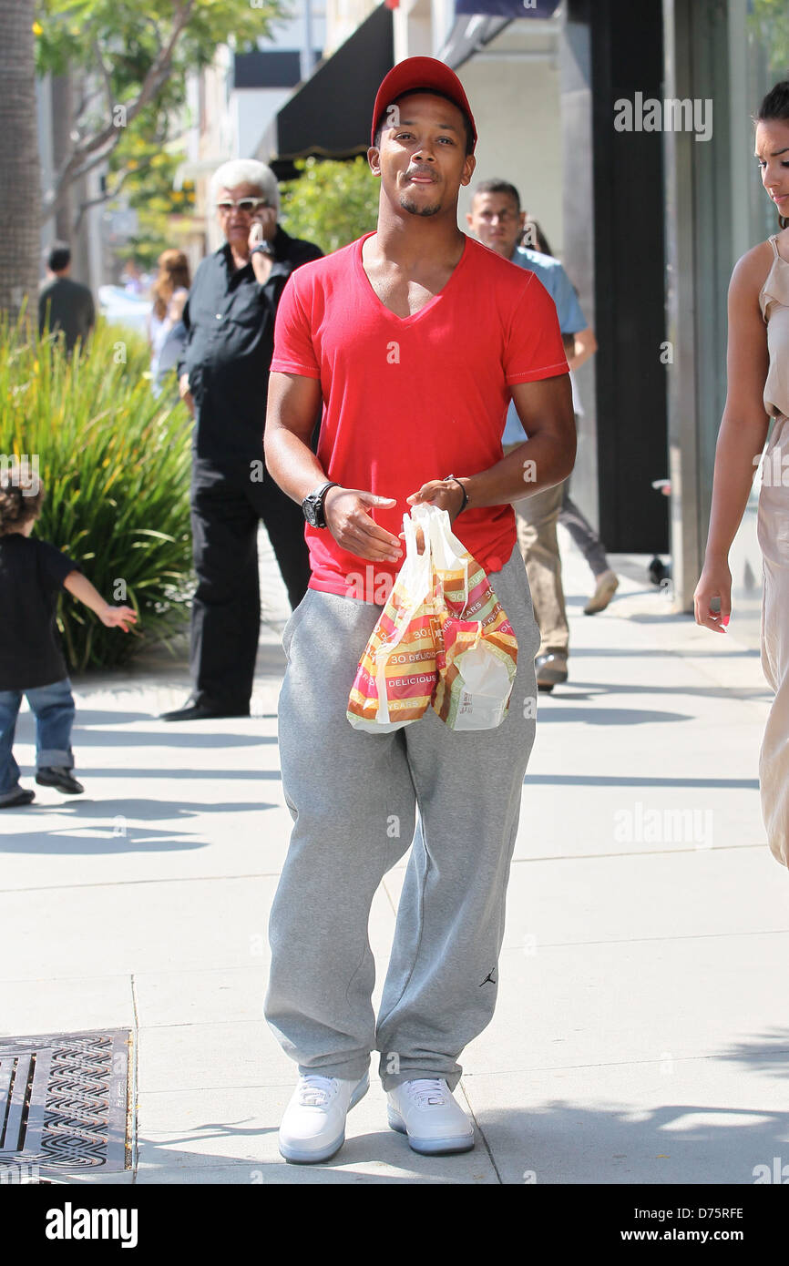 Rapper Romeo adjusts himself while wearing sweatpants as he leaves The Cheesecake Factory with a bag of take out food Los Stock Photo Alamy