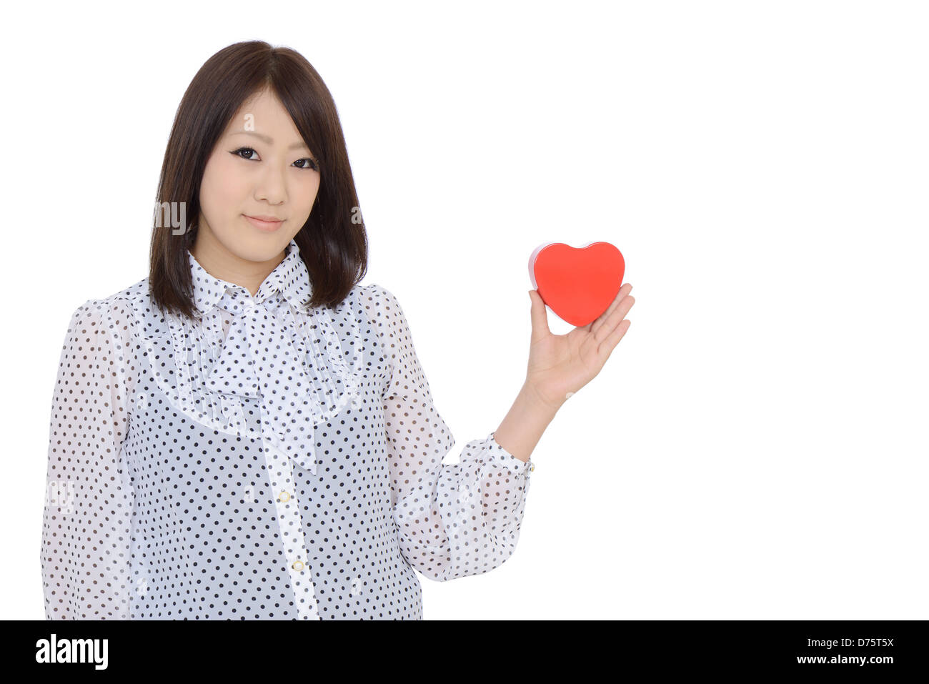 Young asian woman holding a red heart Stock Photo
