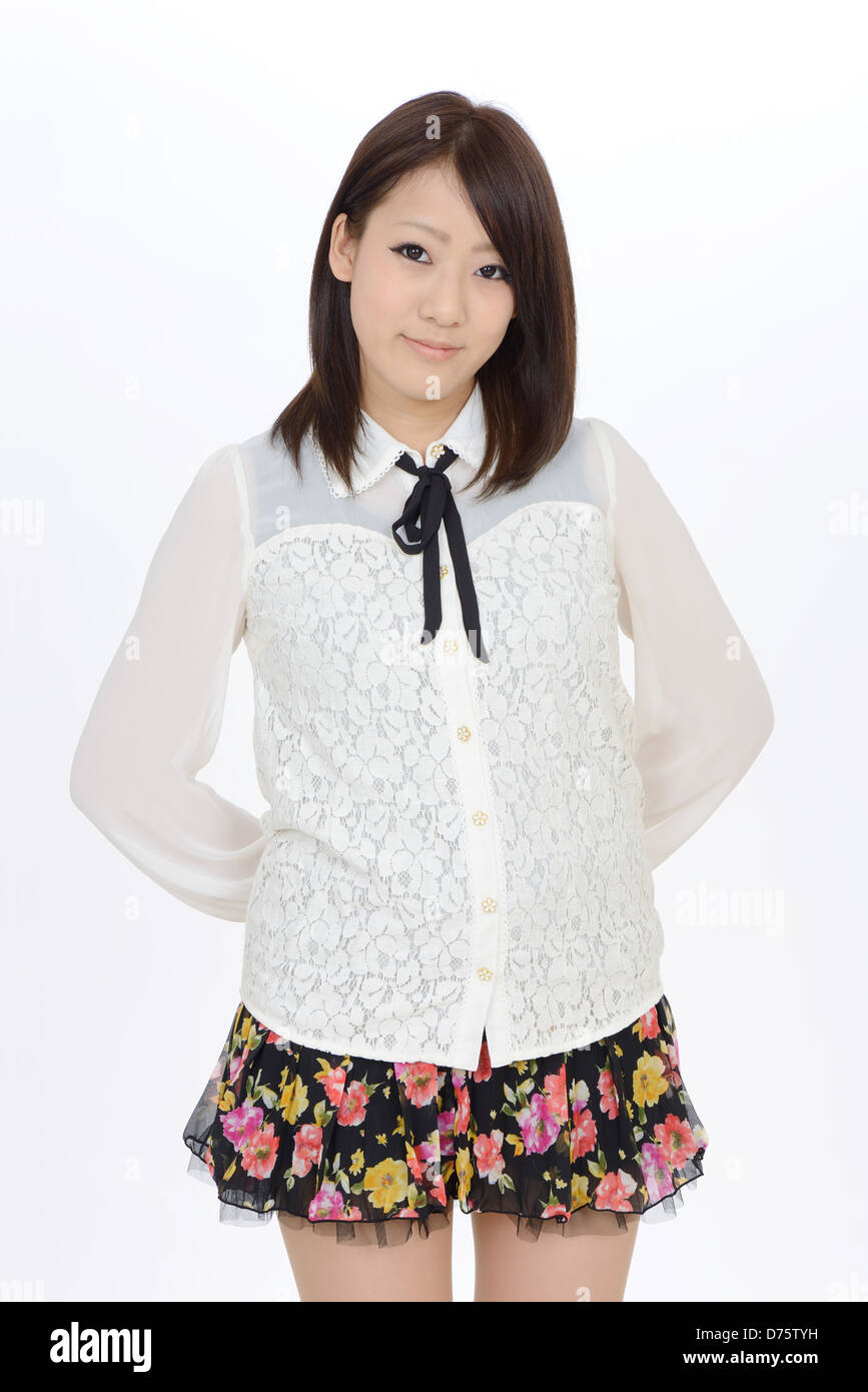 Young asian woman standing with hands at her back Stock Photo - Alamy