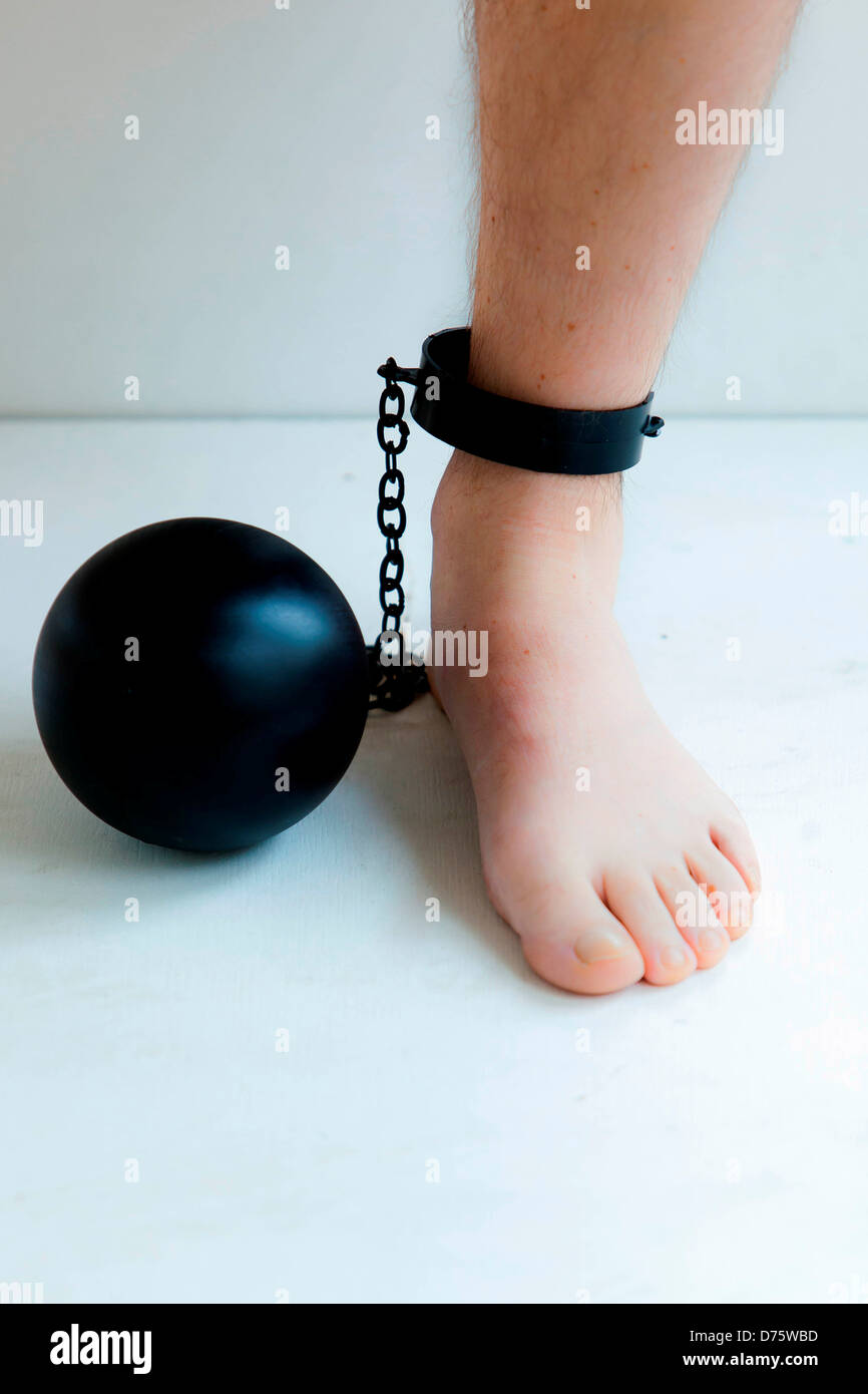 Ball and chain attached to the ankle of a man Stock Photo Alamy