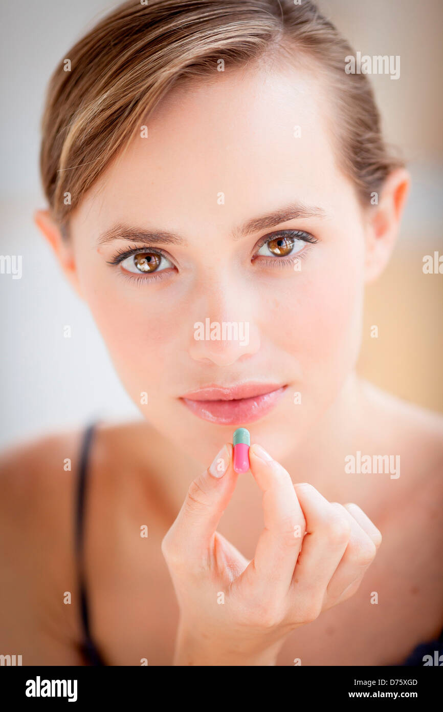 Woman taking gelatine capsule medication Stock Photo Alamy