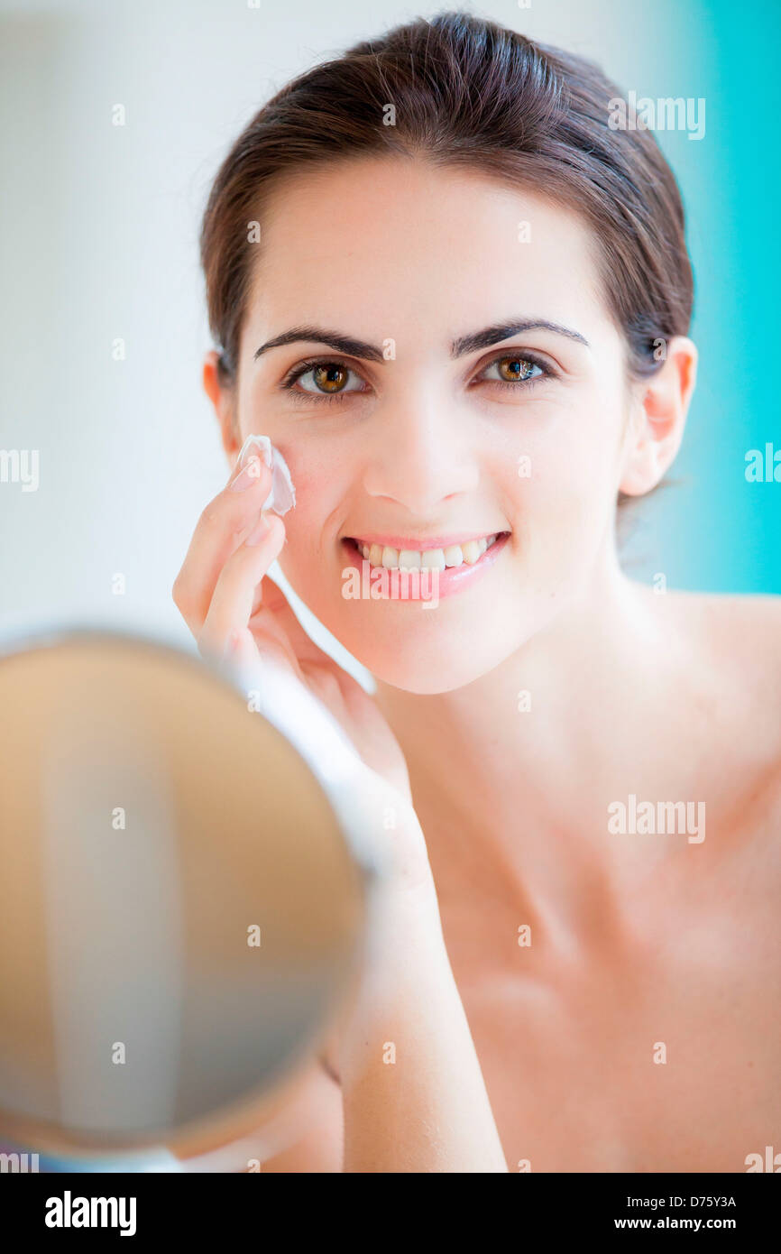 Woman 40 applying cream face bathroom hi-res stock photography and ...