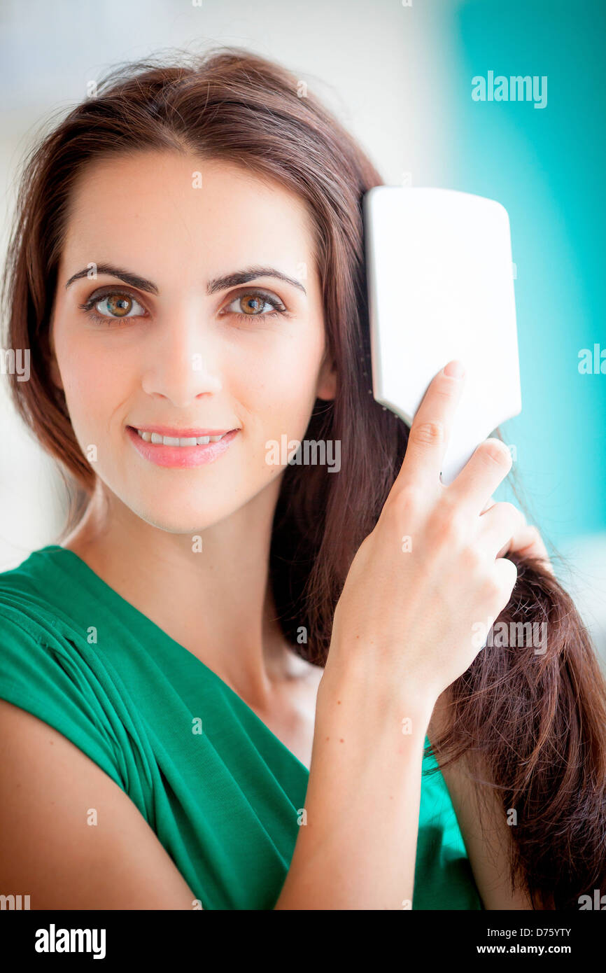 Woman brushing her hair Stock Photo Alamy