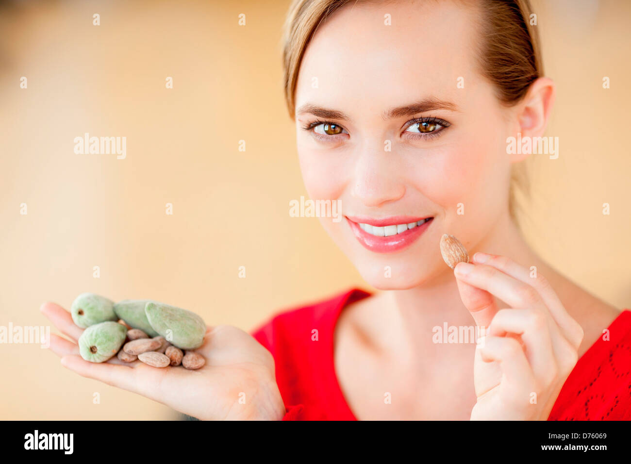 Woman eating almonds Stock Photo Alamy