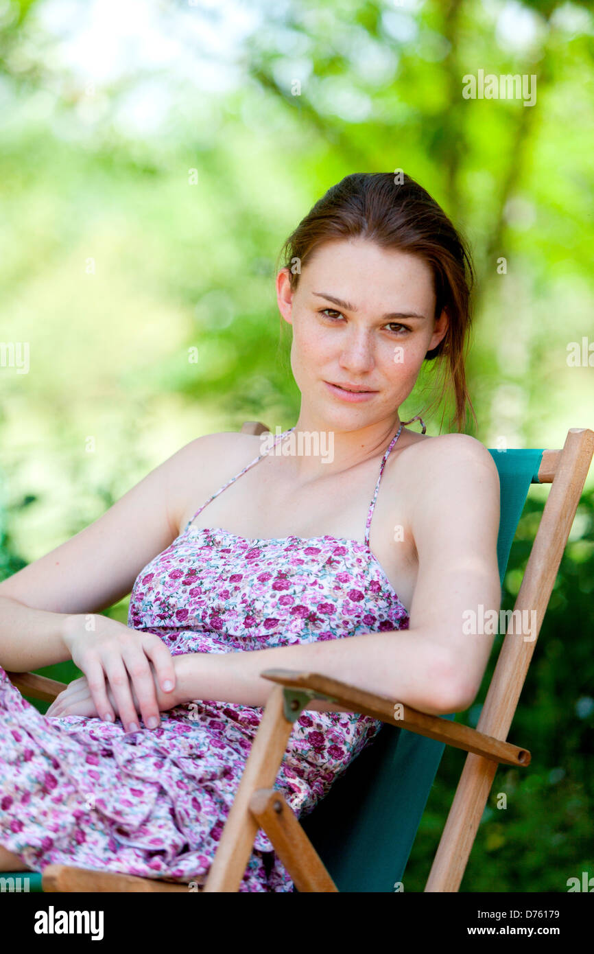 Woman relaxing outdoors Stock Photo - Alamy