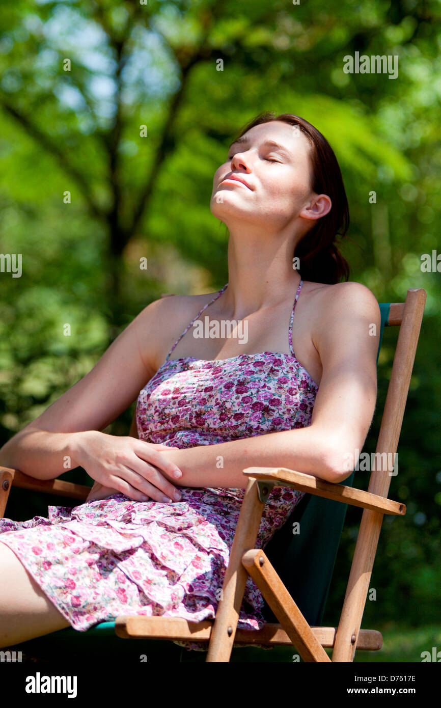 Woman relaxing outdoors Stock Photo - Alamy