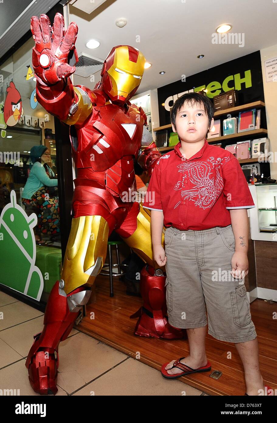 Surabaya, Indonesia. April 28, 2013. A replica of the American super hero, Iron Man, in action to entertain visitors Plaza Marina, gadgets and electronics shopping center in Surabaya. Iron Man 3 is booming in Indonesia, almost in every show, hundreds of spectators specially children lining up to watch the film. (Photo by Robertus Pudyanto/AFLO/Alamy Live News) Stock Photo