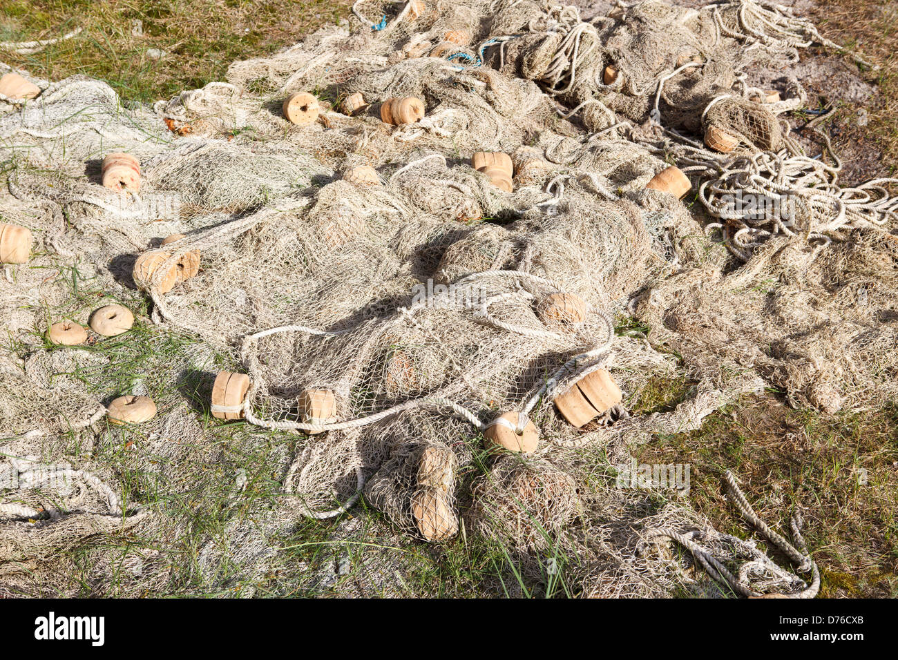 Olf fishnet drying in meadow Stock Photo