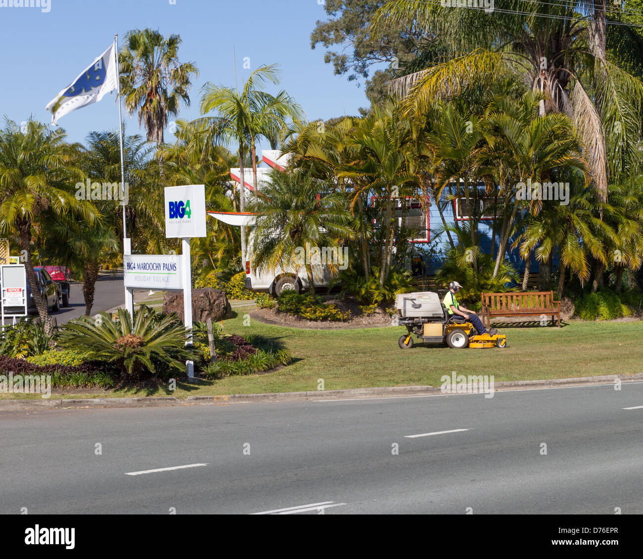 Man using rideon mower to mow lawns at Big 4 Maroochy Palms caravan