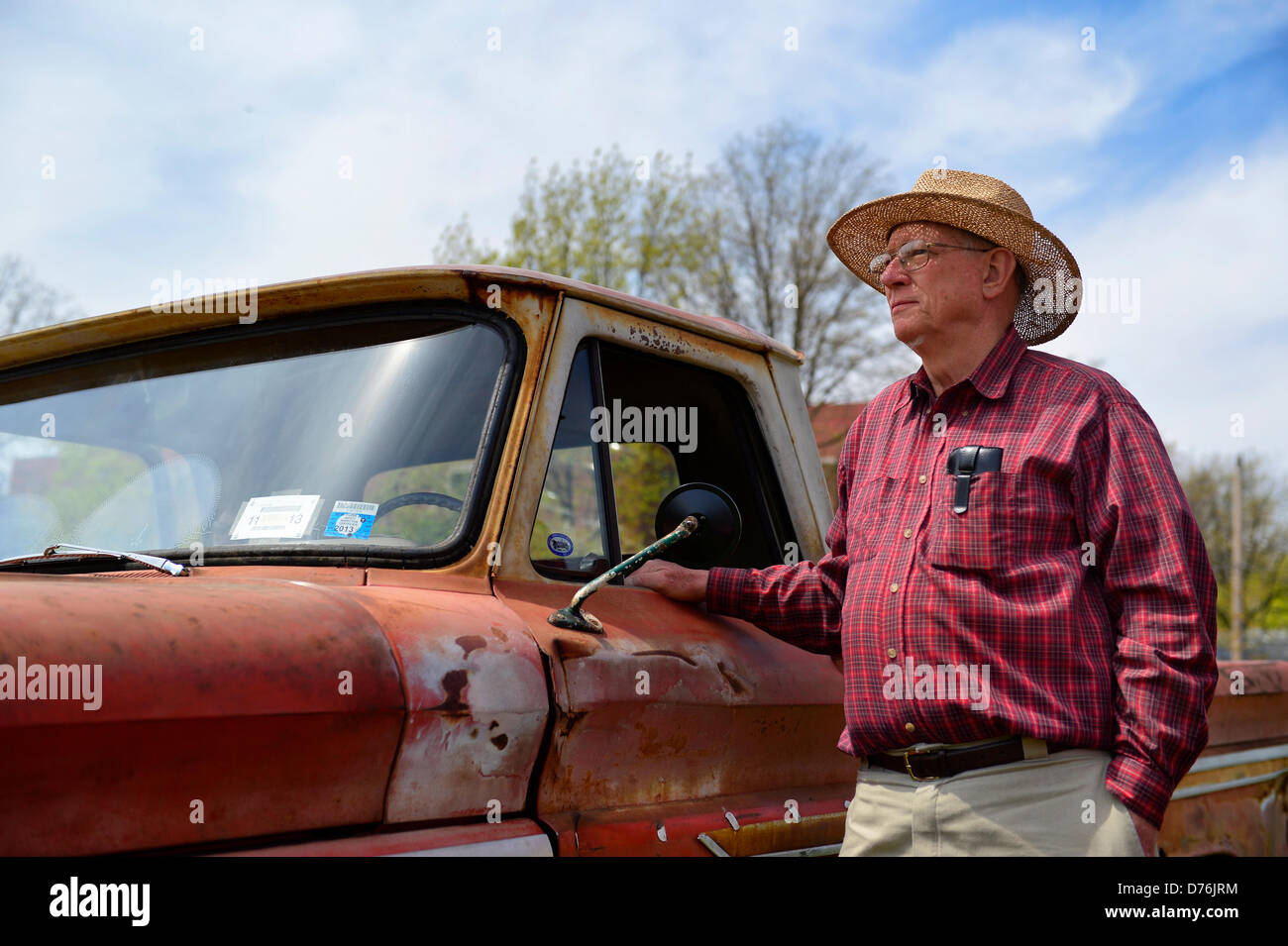 Floral Park, New York, U.S. April 28, 2013. PAUL GRAMLICH is standing next his red and white 1964 Chevrolet C-10 pickup at the Antique Auto Show, where New York Antique Auto Club members exhibited their cars on the farmhouse grounds of Queens County Farm Museum. Gramlich explained that the truck, now rusted, which he and his wife Janet own, has been in the Gramlich family since it was new. Credit: Ann E Parry/Alamy Live News Stock Photo