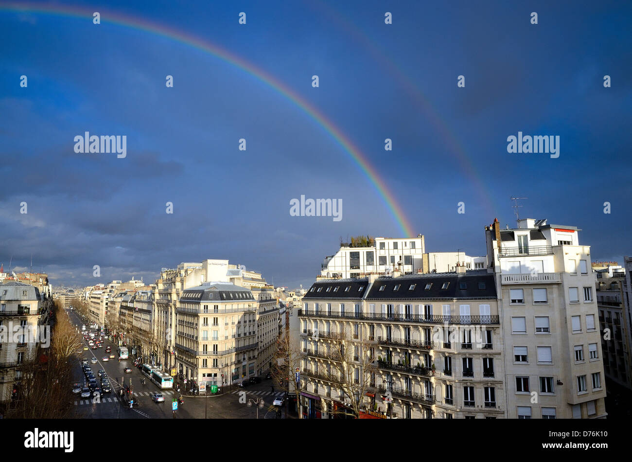 Boulevard Haussmann skyline with rainbow against dark blue sky Paris France EU Stock Photo
