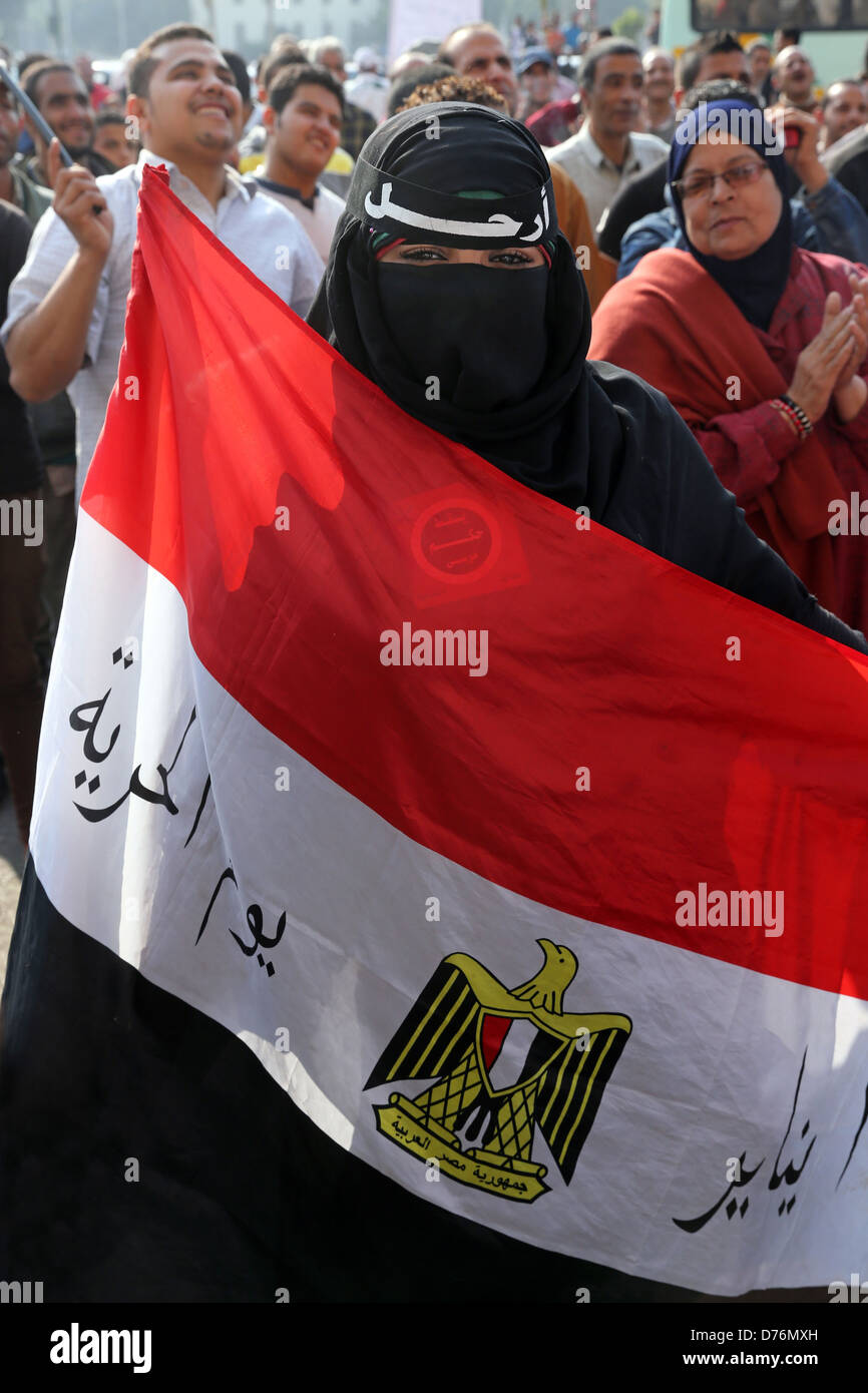 Muslim women with egyptian flag wearing full burqa garment at a demonstration on Tahrir Square in Cairo, Egypt Stock Photo