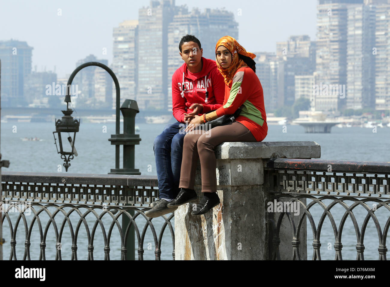 young couple holding hands on the nil river banks, Cairo, Egypt Stock Photo