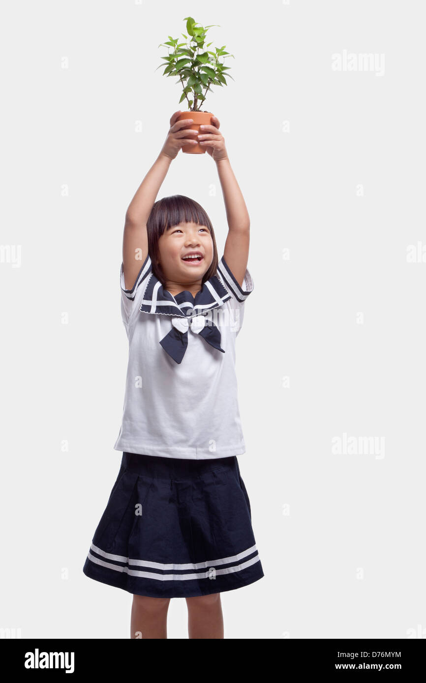 Girl Holding Potted Plant Over Her Head Stock Photo - Alamy