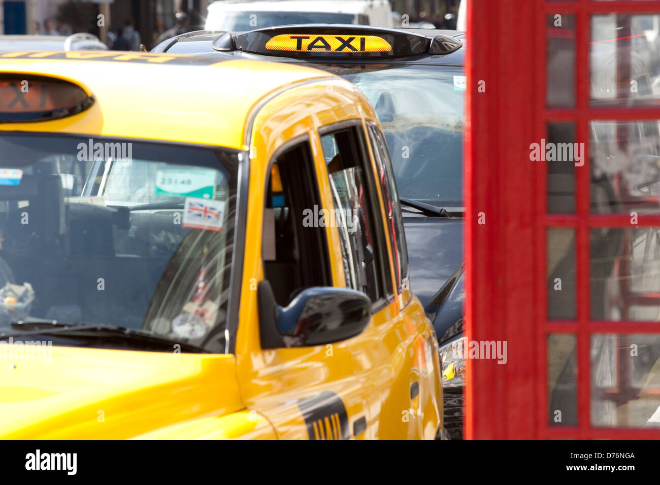 London Taxi London Taxi and phone box, Yellow Taxi, Taxi for hire, London Cabs, London, Taxi, London Street scene. Busy London. Stock Photo