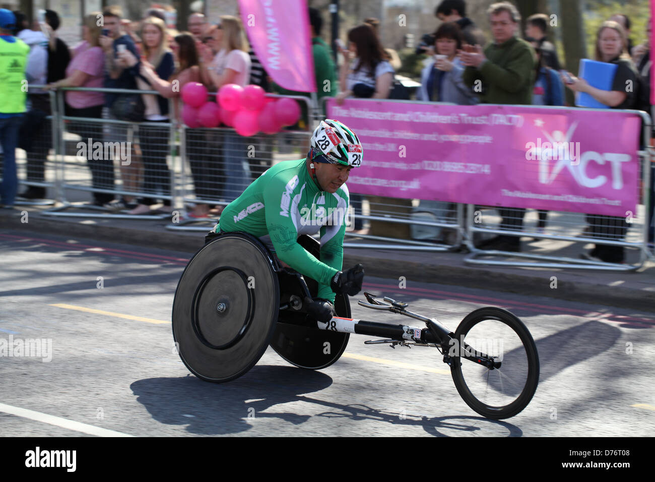 A wheelchair athlete competes in the 2013 Virgin London Marathon for charity Stock Photo