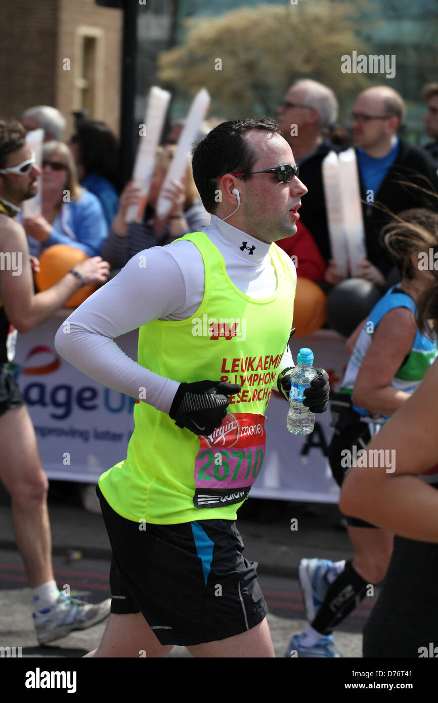 A runner competes in the 2013 Virgin London Marathon for charity Stock Photo