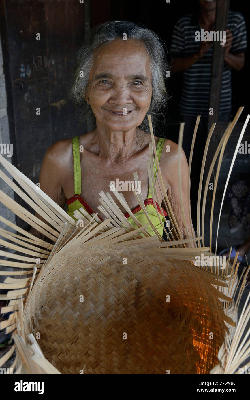Asia Indonesia Bali Village of Sidatapa, elderly woman making basketry Stock Photo