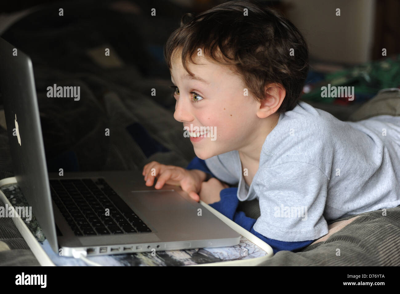 8 year old boy playing on an apple mac laptop computer in his bedroom at home Stock Photo - Alamy 8 year old boy playing on an apple mac laptop computer in his bedroom at home Stock Photo - Alamy