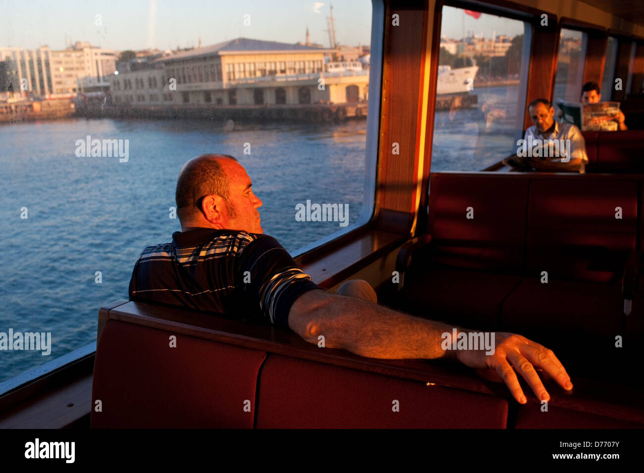 A Turkish passenger on a ferry crossing Bosphorus from Eminonu to Kadikoy, Istanbul, Turkey. Stock Photo