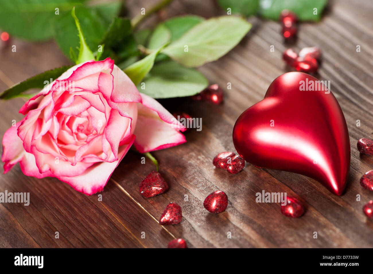 Hearts with roses on wooden background Stock Photo - Alamy