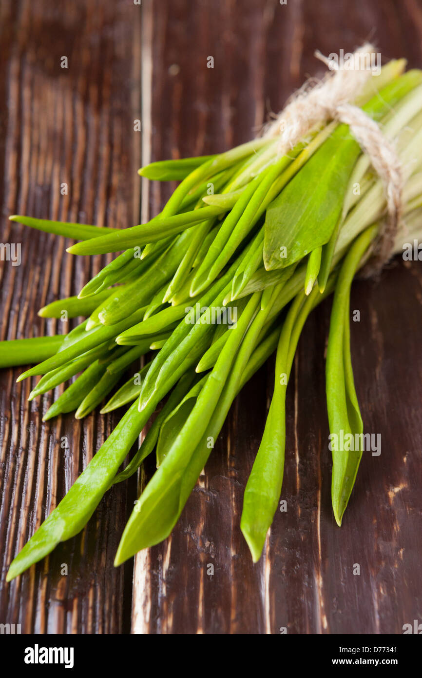 bunch of wild garlic on wooden table, food Stock Photo
