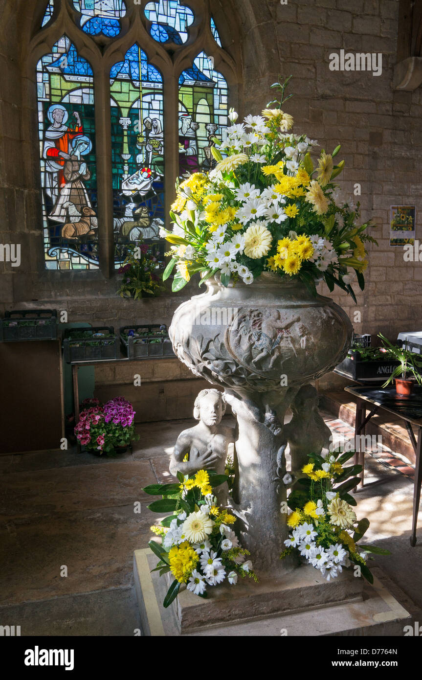 Flower arrangement in the font of All Saints Church Moulton, Lincolnshire, England, UK Stock
