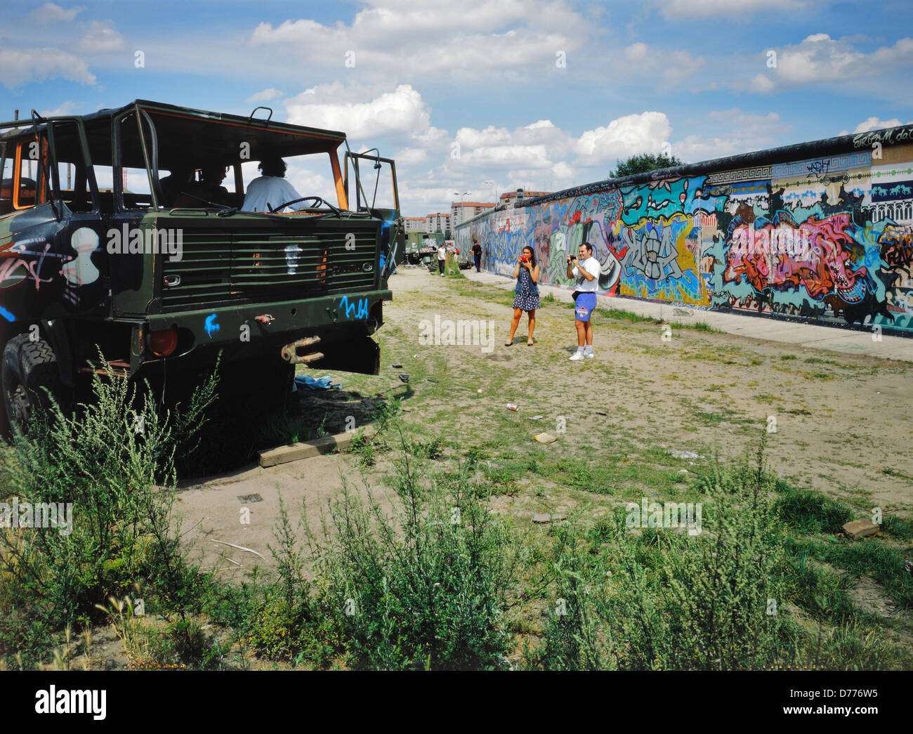 Berlin, Germany, old army trucks and tourists on the Berlin Wall Stock Photo