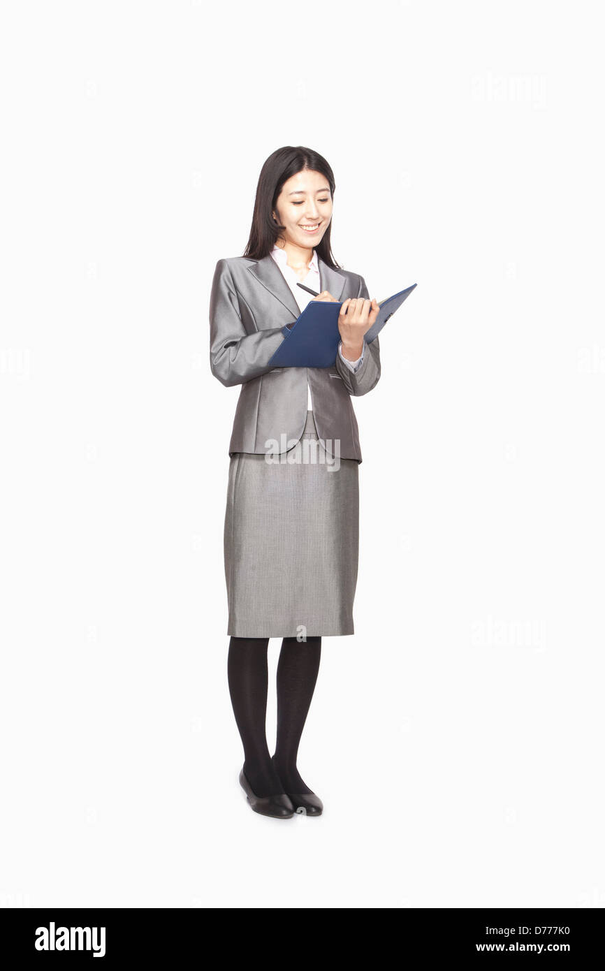 Businesswoman taking notes Stock Photo
