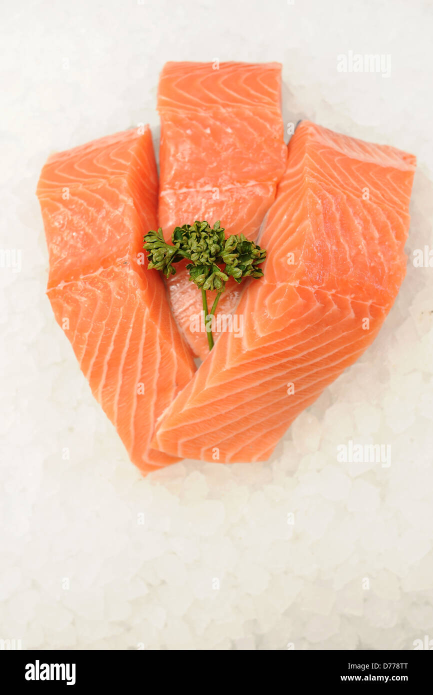 Three salmon fillets on a bed of ice. Stock Photo