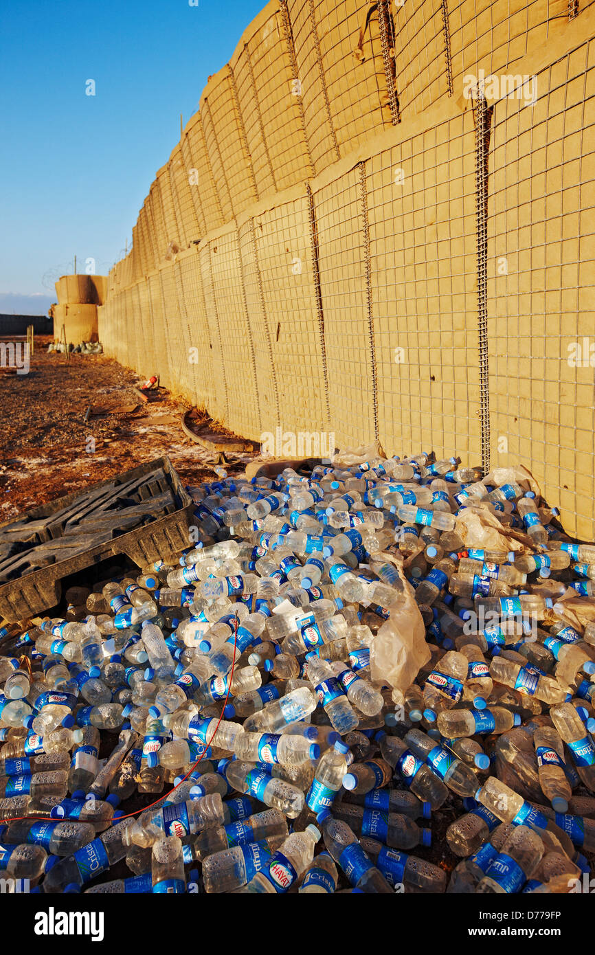 Pile Water Bottles Against Hesco Barrier at U.S. Marine Corps Forward Operating Base in Afghanistan's Helmand Province. Stock Photo