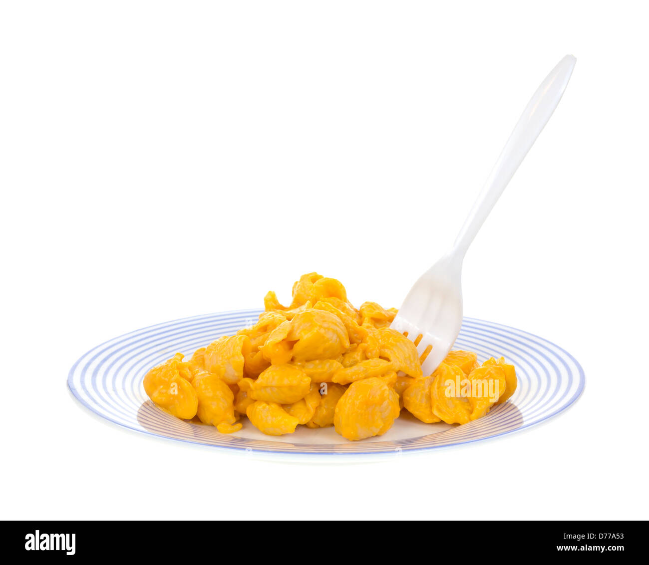 A blue striped plate with a serving of pasta shells with cheese sauce and a fork sticking into the meal. Stock Photo