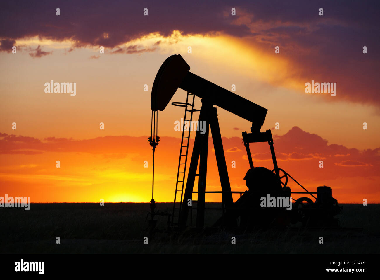 Oil Well Pump Jack at Sunset Stock Photo