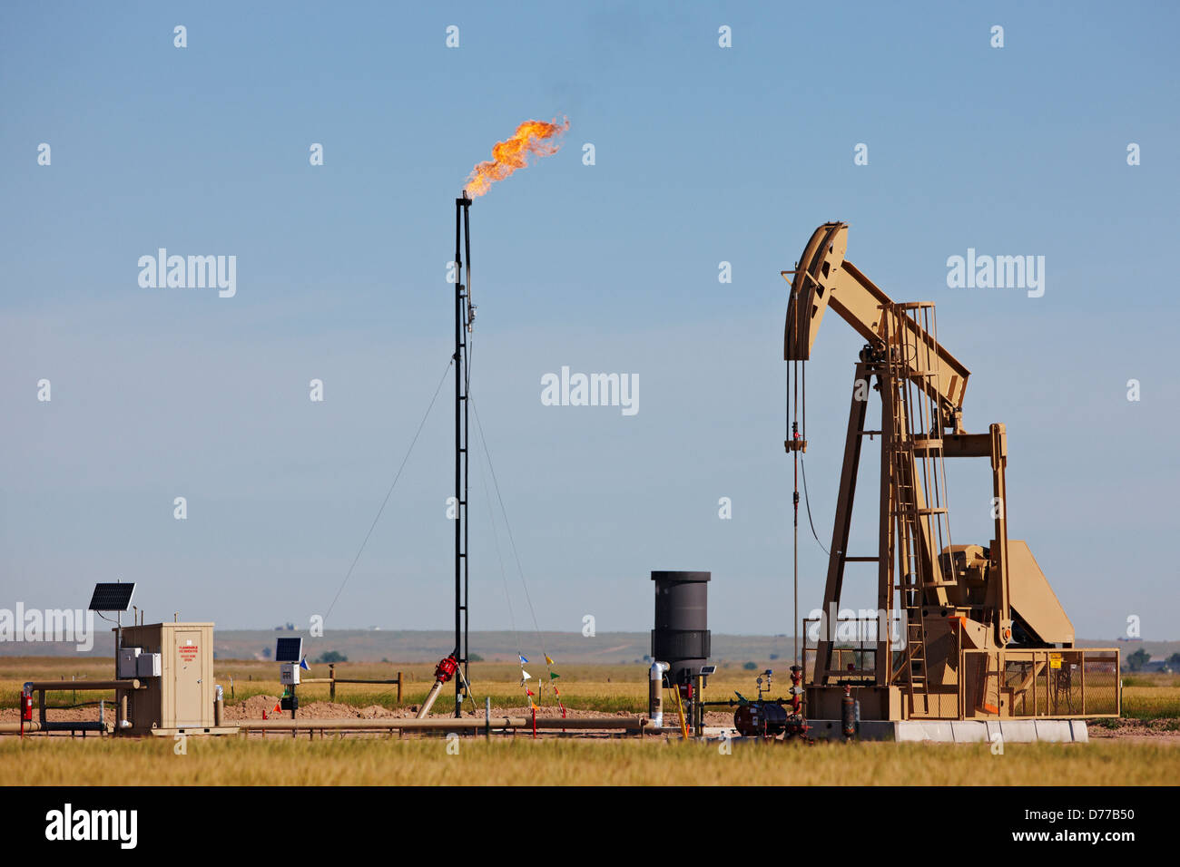 An Oil Well Pump Jack Natural Gas Flare Tower Stock Photo Alamy