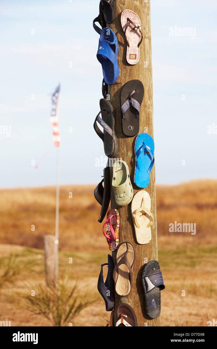 Flip-Flops sandals nailed to pole after hurricane Holly Beach Louisiana USA Stock Photo